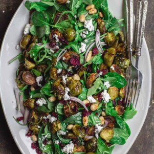 Mediterranean roasted brussels sprouts salad on large serving platter