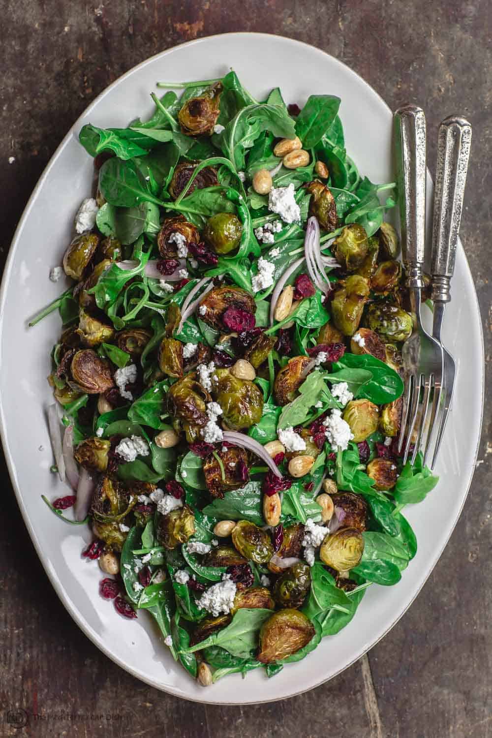 Mediterranean roasted brussels sprouts salad on large serving platter