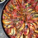 Briam. Traditional Greek Roasted Vegetables with potatoes, zucchini, red onions, tomatoes and extra virgin olive oil