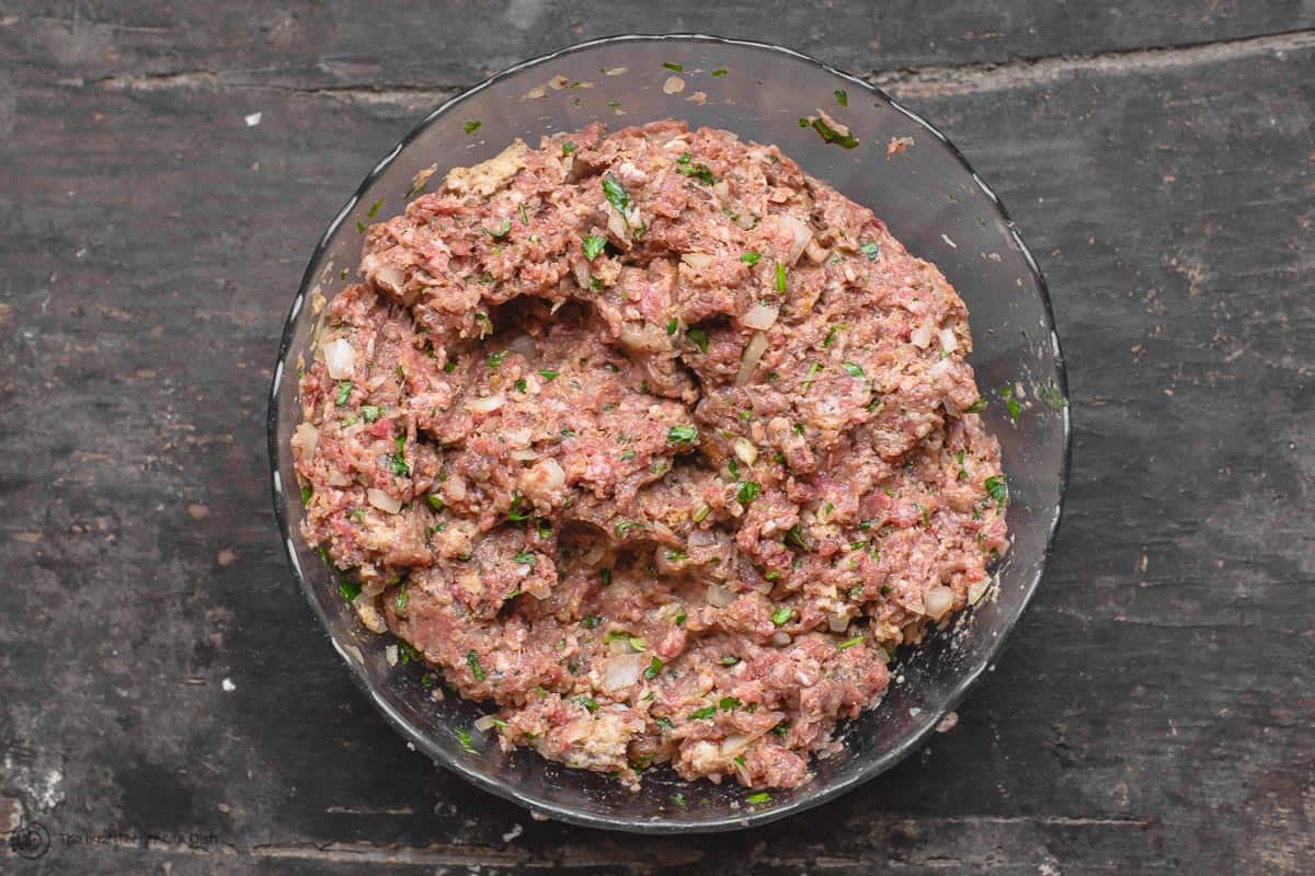 Meatball ingredients combined into a kneaded meat mixture