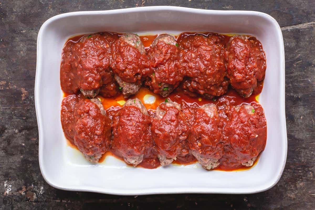 Sauce added on top of meatballs in baking dish