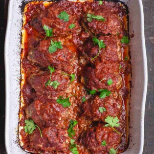 Greek Baked Meatballs with Red Sauce. Garnished with Parsley