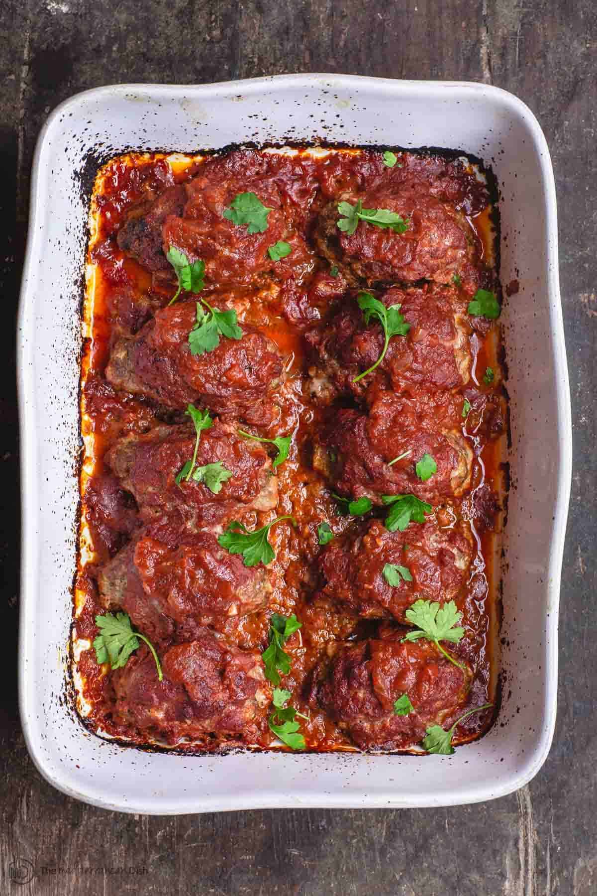 Greek Baked Meatballs with Red Sauce. Garnished with Parsley
