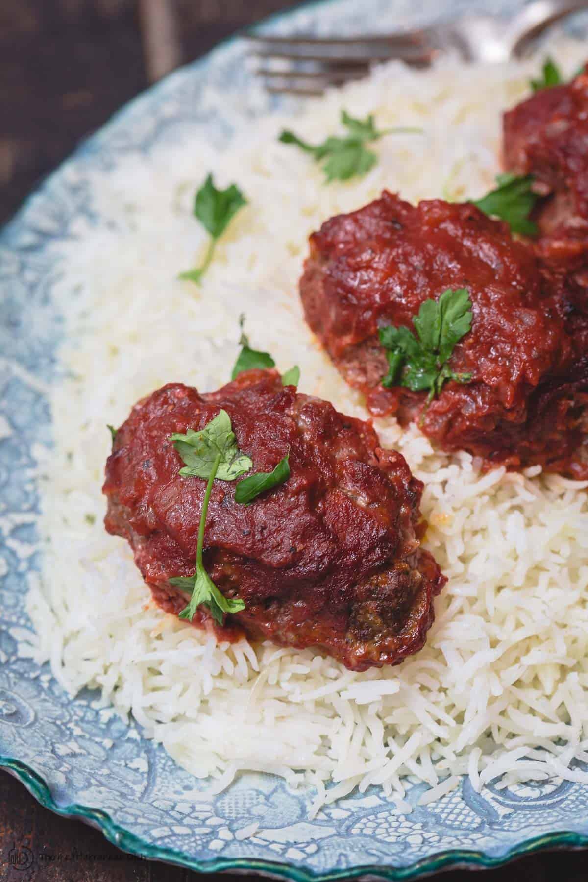 Close look at baked Greek meatballs and rice.