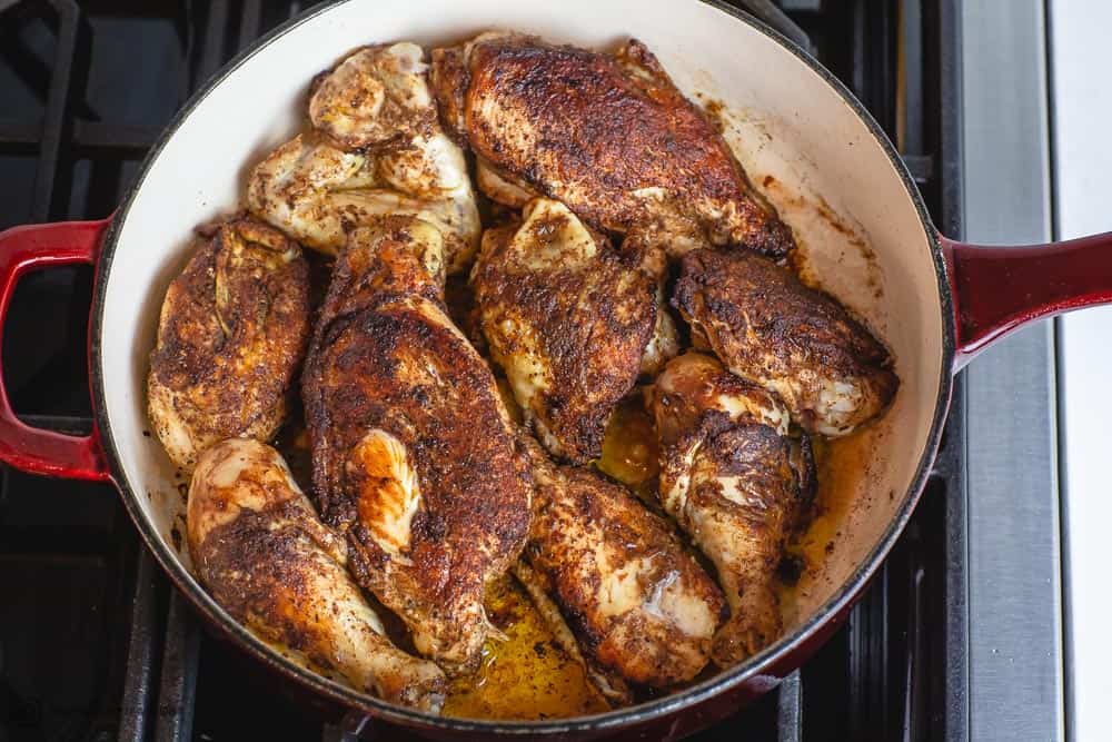 Moroccan chicken being browned in braiser