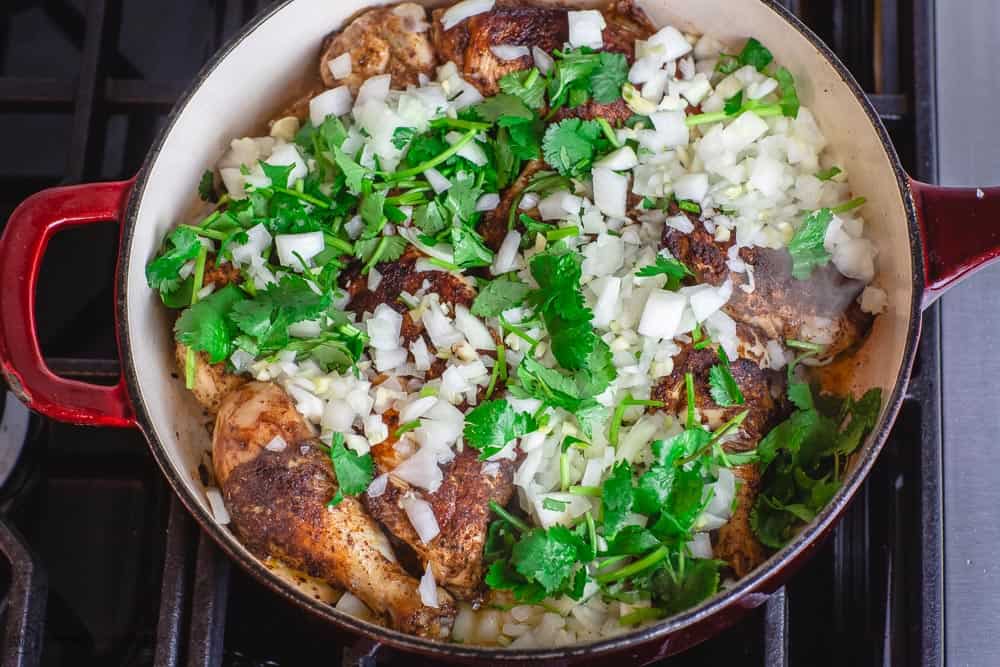 Onions, garlic, and cilantro added to Moroccan chicken