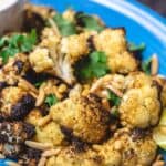 Roasted cauliflower with cumin and lemon, served with a side of tahini