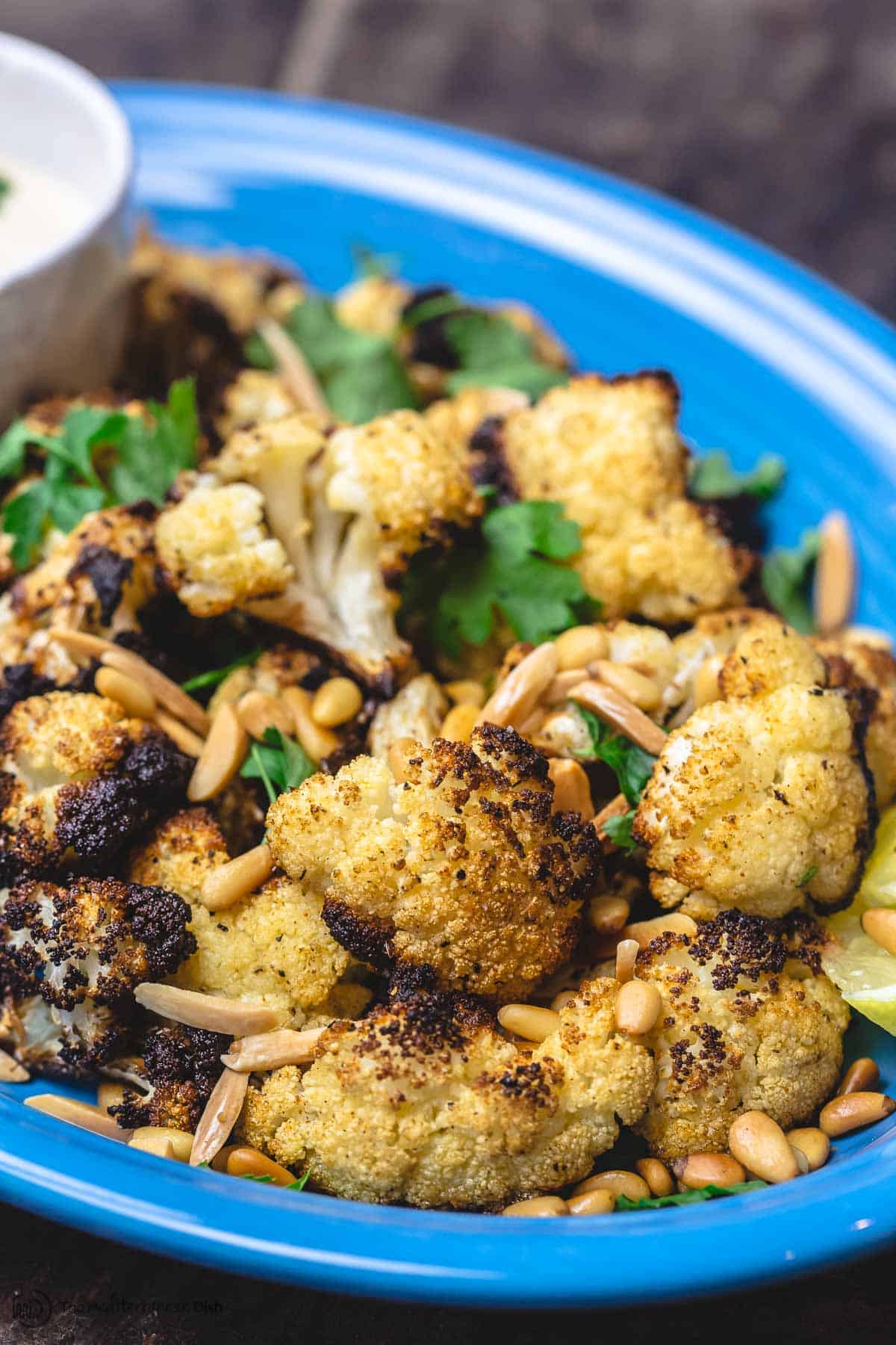 Roasted cauliflower with cumin and lemon, served with a side of tahini