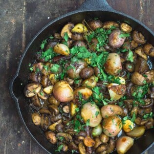 Shallot Garlic Mushroom recipe. Served in large cast iron skillet with parsley garnish.