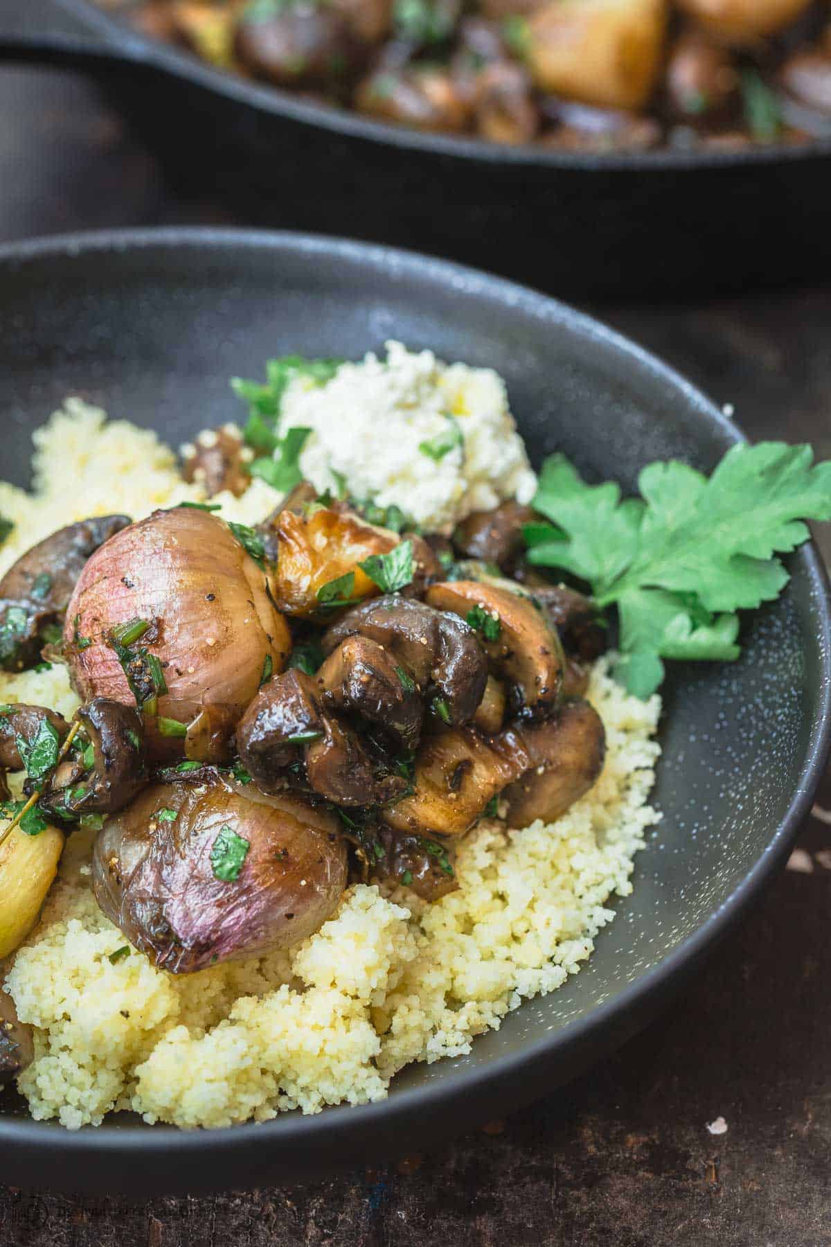 Shallot garlic mushrooms served on top of cooked instant couscous with a dollop of lemon ricotta on top