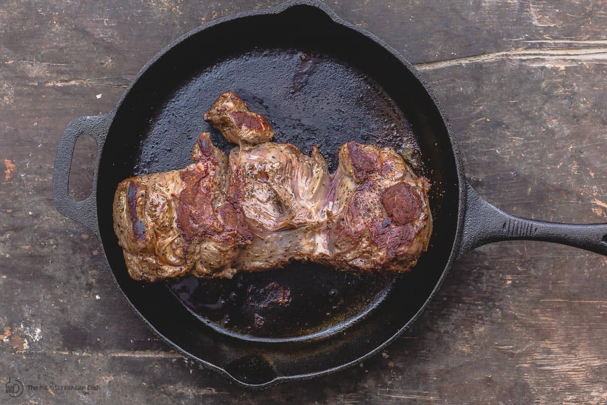 Boneless lamb leg browned in cast iron skillet