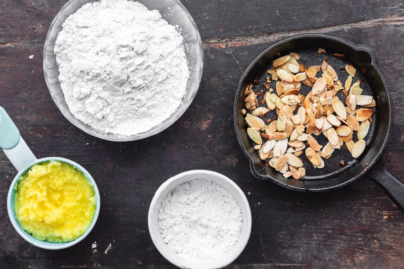 ingredients for butter cookies: ghee, powdered sugar, and flour. Toasted shaved almonds (optional)