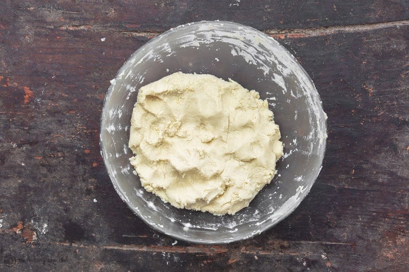 Baking powder and flour have been added. Ghoryebah butter cookie dough formed in a bowl. 