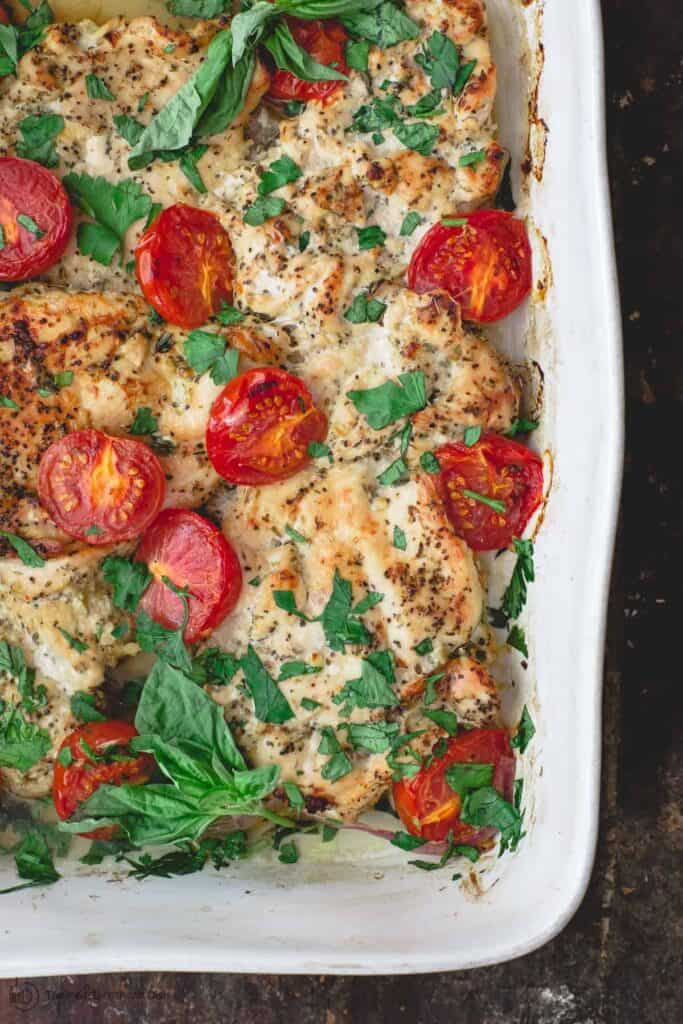 Italian Baked Chicken with Tomatoes. Garnished with Basil and Parsley