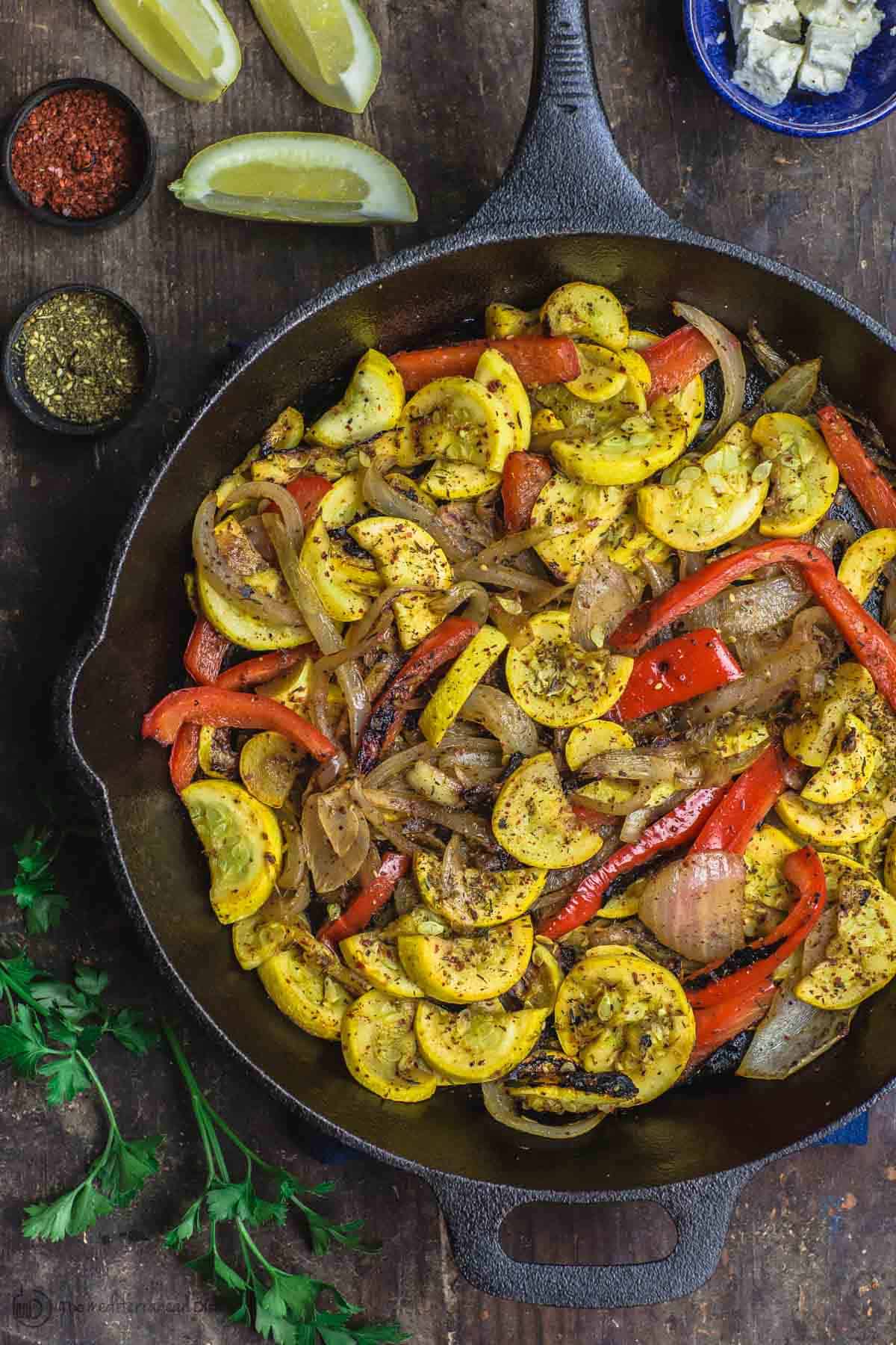 Mediterranean Sauteed Yellow Squash with Sweet Onions, Bell Peppers and Garlic in Cast Iron Skillet