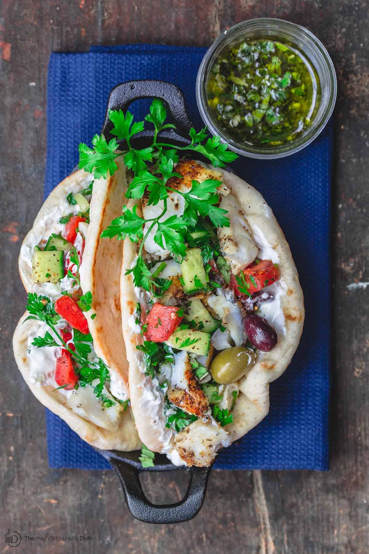 Grilled cod gyros with a side of lemon basil sauce