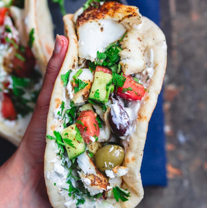 Grilled cod assembled gyro-style in pita wraps
