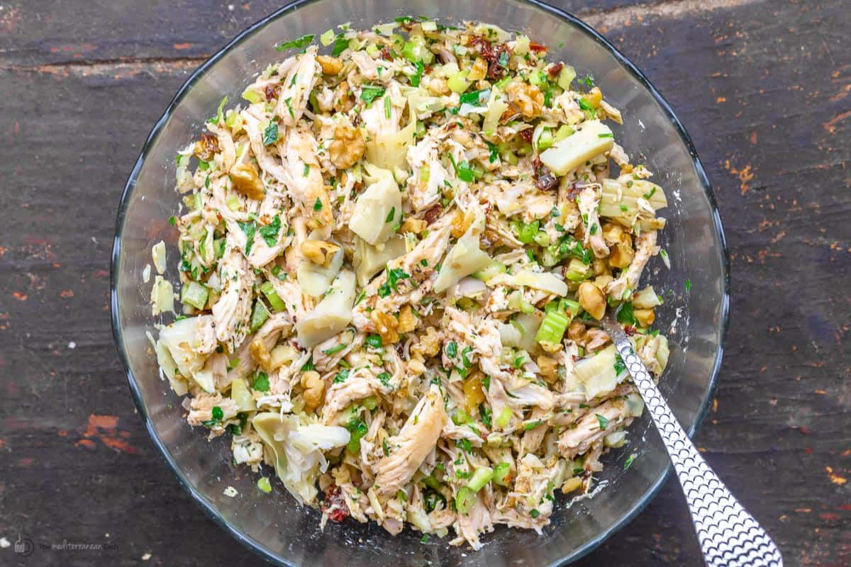 chicken, vegetables, and herbs tossed together in a bowl