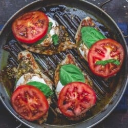 Finally, add fresh basil and tomato slices to complete caprese chicken