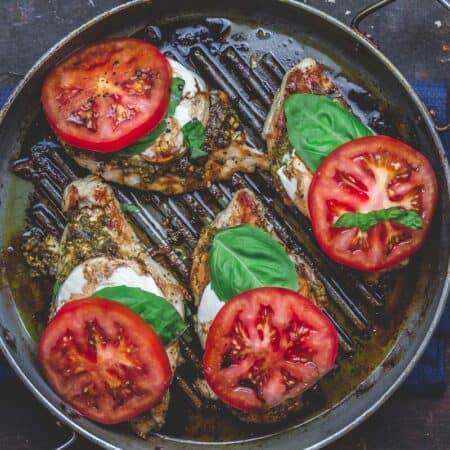 Finally, add fresh basil and tomato slices to complete caprese chicken