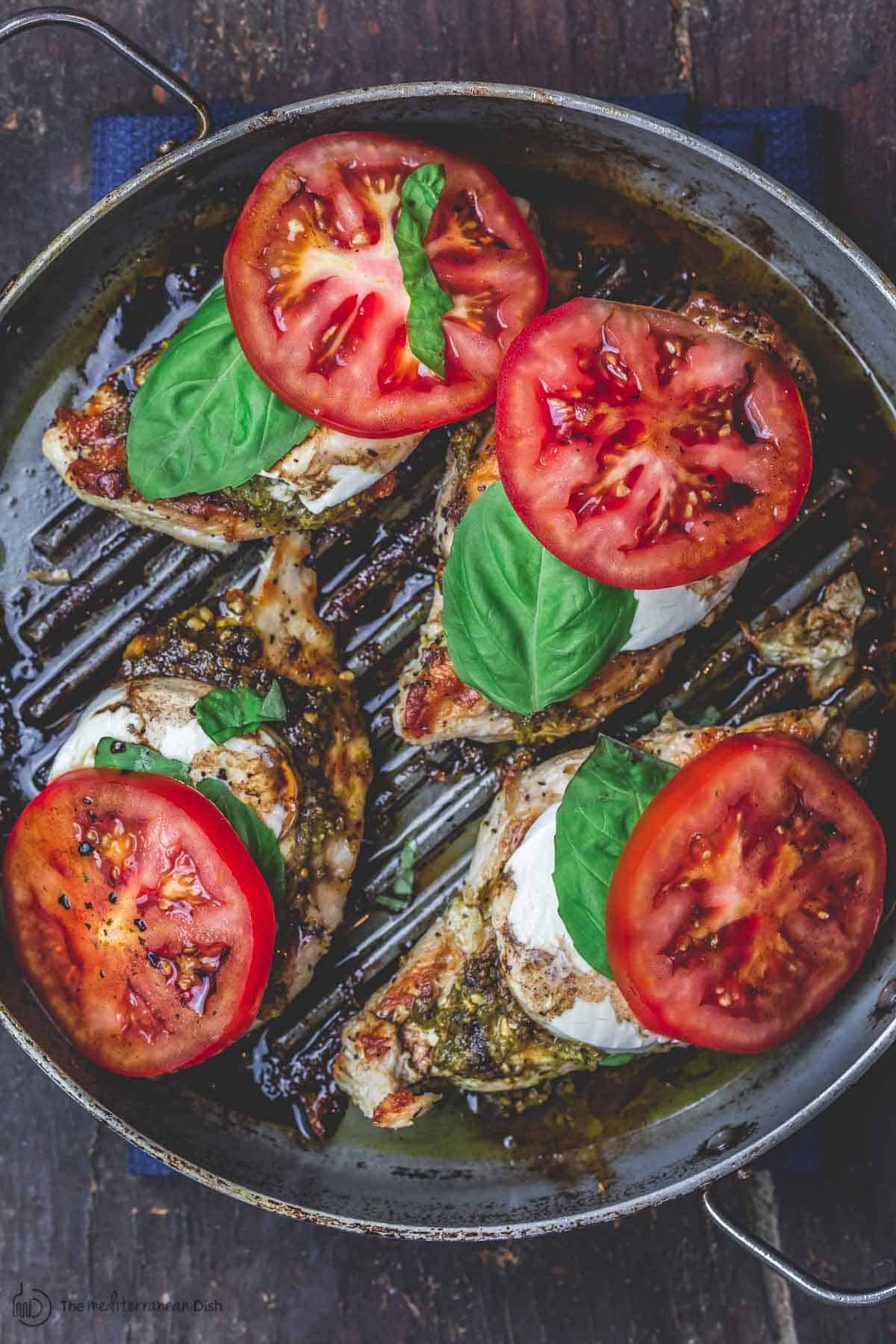 Easy Caprese Chicken with basil pesto, fresh mozzarella, ripe tomatoes, and balsamic glaze