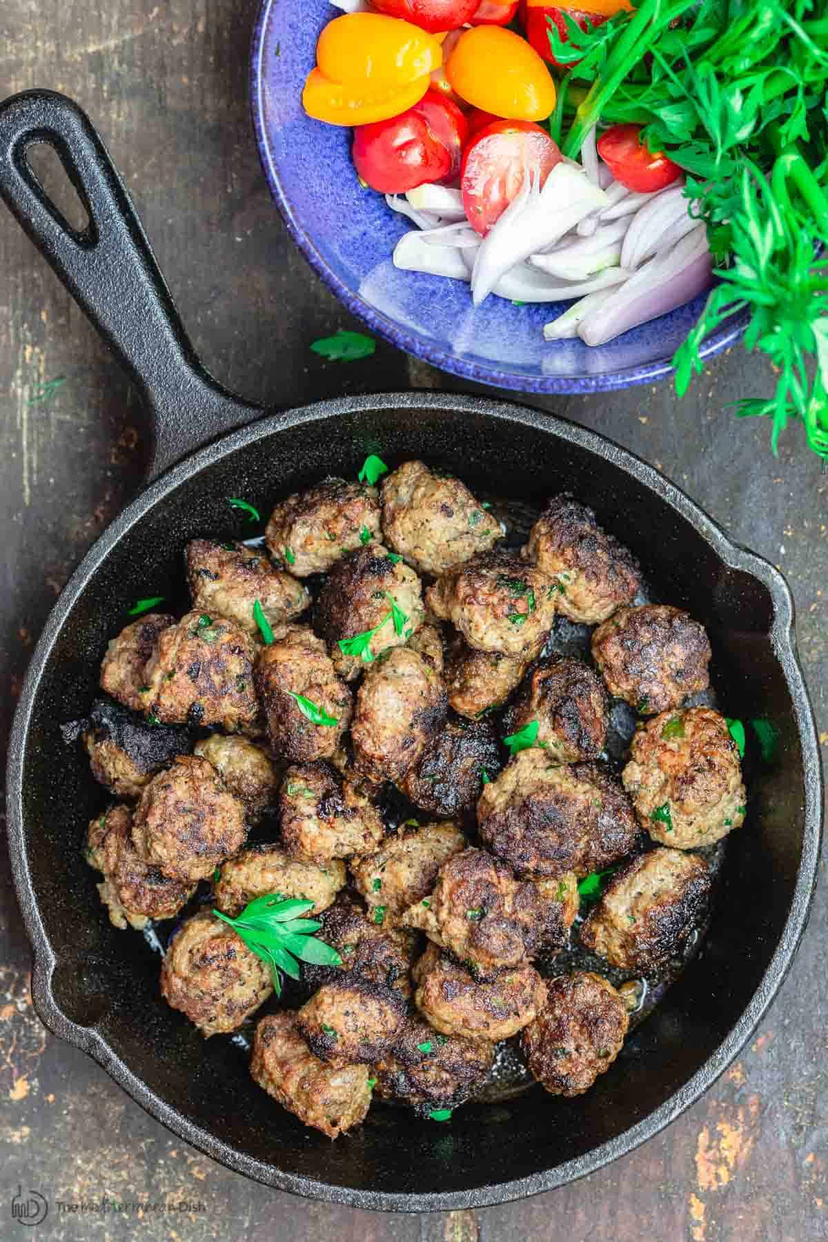 Moroccan Meatballs with a Side of Sliced Cherry Tomatoes, Onions, Fresh Herbs