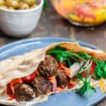 Moroccan Meatballs served in Pita Pockets with Fresh Vegetables and Carrot Salad. A side of Olives