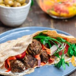 Moroccan Meatballs served in Pita Pockets with Fresh Vegetables and Carrot Salad. A side of Olives