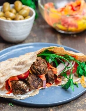 Moroccan Meatballs served in Pita Pockets with Fresh Vegetables and Carrot Salad. A side of Olives