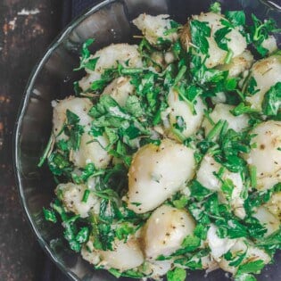 Simple boiled potatoes, tossed with garlic, fresh herbs and extra virgin olive oil