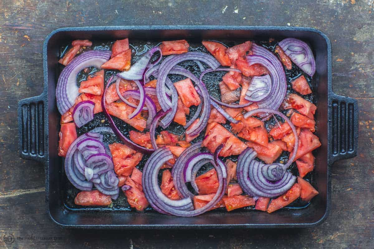 Baking sheet with onions and tomatoes