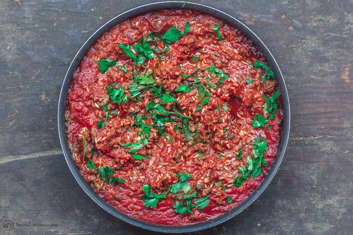 Meat and rice mixture with tomato sauce. Stuffing for tomatoes