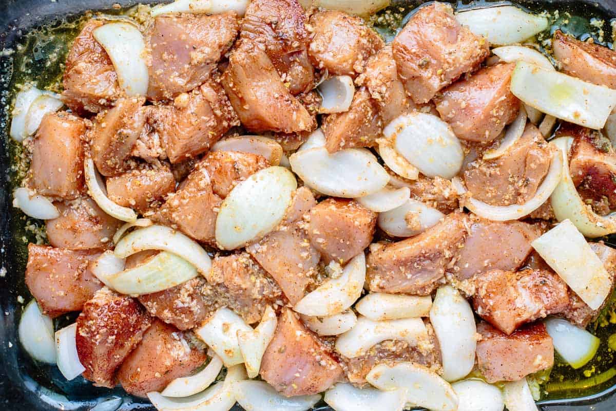 Cubed chicken pieces marinated with onions.