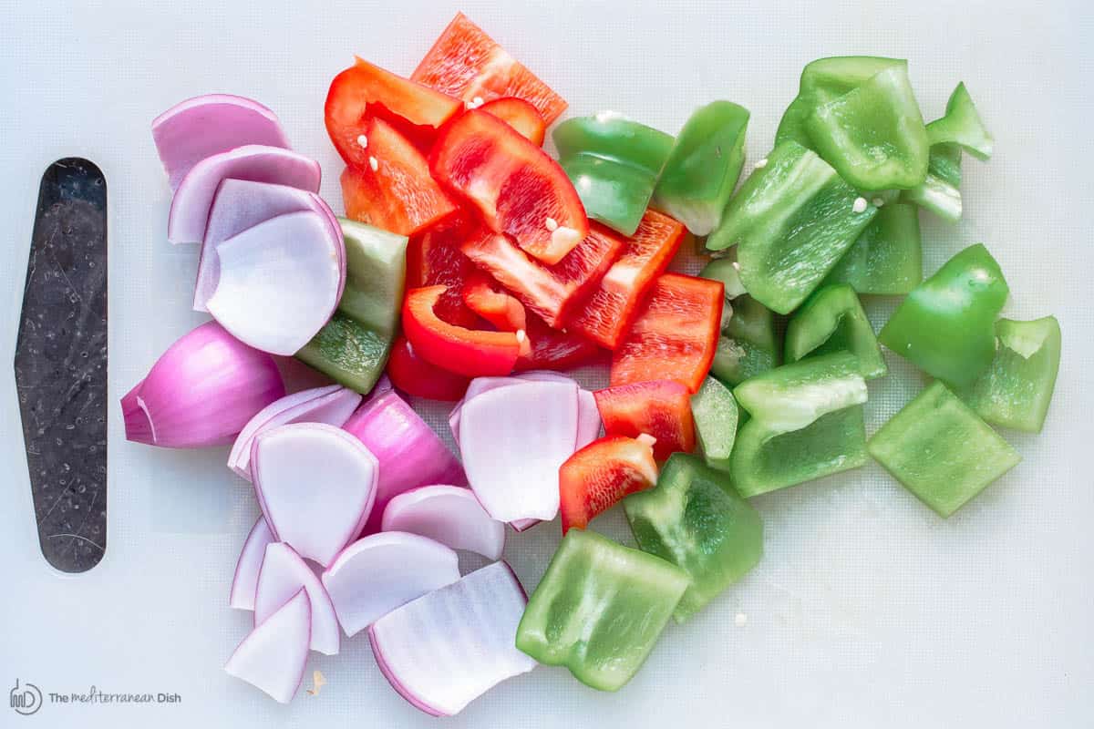 Chopped pieces of red onion, red and green peppers.