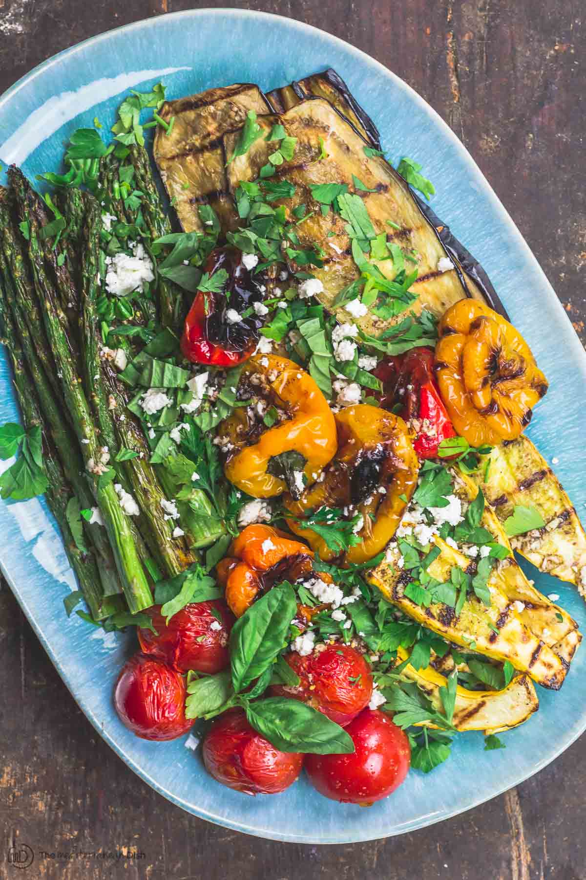 Grilled Vegetables Platter topped with Mediterranean dressing, fresh herbs and feta cheese.