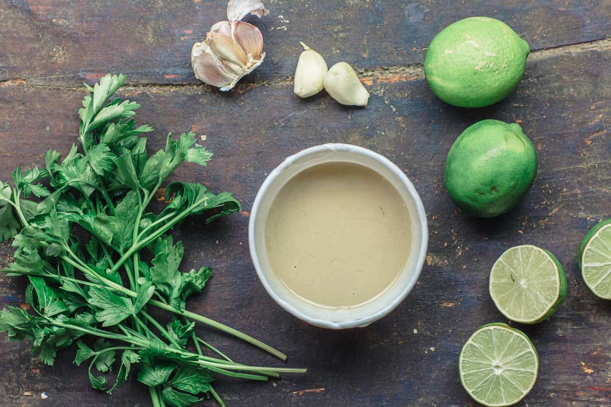 Tahini sauce ingredients. tahini paste, garlic, lime, parsley