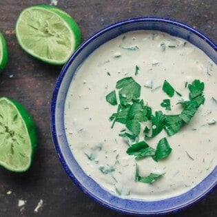 Tahini sauce with parsley. Lime juice to the side