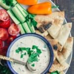Tahini Sauce Platter with fresh vegetables and pita wedges
