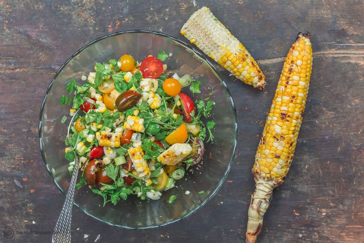 Grilled corn mixed with grape tomatoes, green onions and parsley