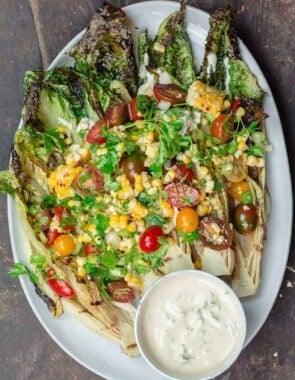 Grilled Lettuce Salad with corn, tomatoes, and a side of tahini sauce