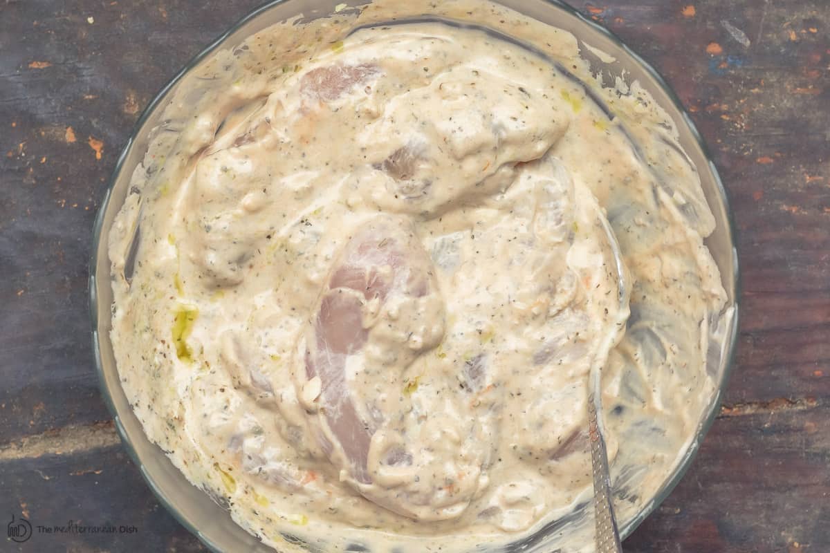 Chicken gyros marinating in bowl