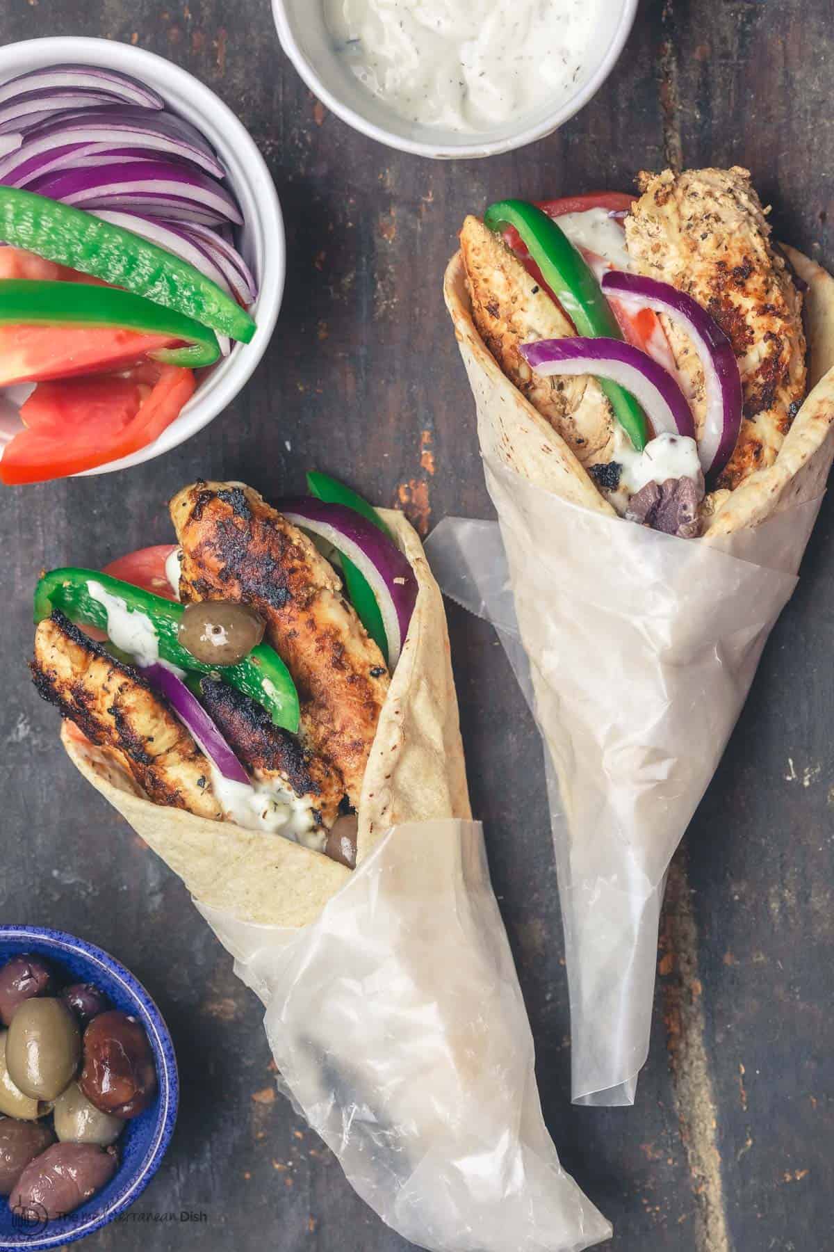 Chicken gyro wraps with tzatziki sauce, tomatoes and olives