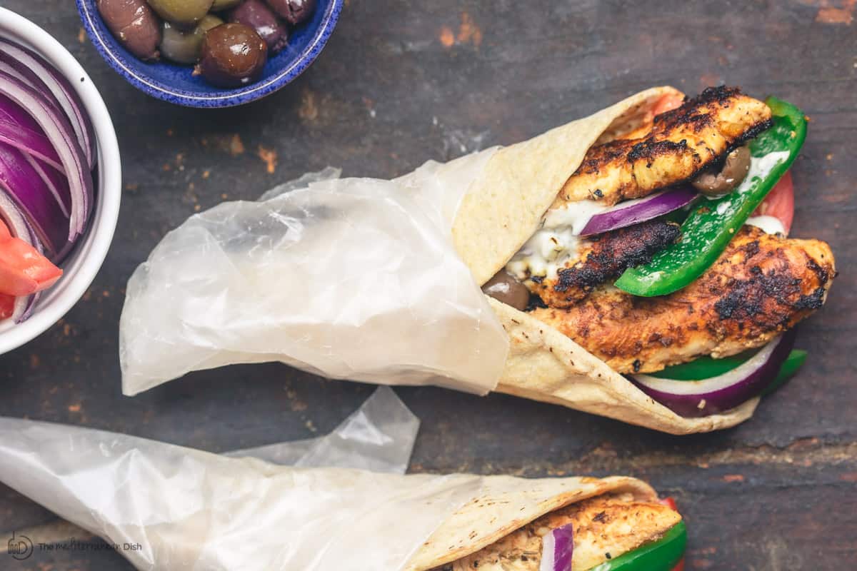 Chicken gyro wraps with tzatziki sauce, tomatoes and olives
