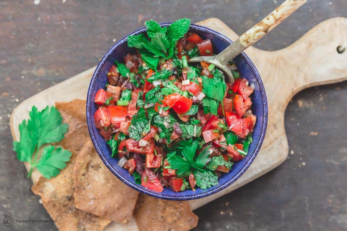 Mediterranean fresh salsa with fresh herbs and olives, served with pita chips