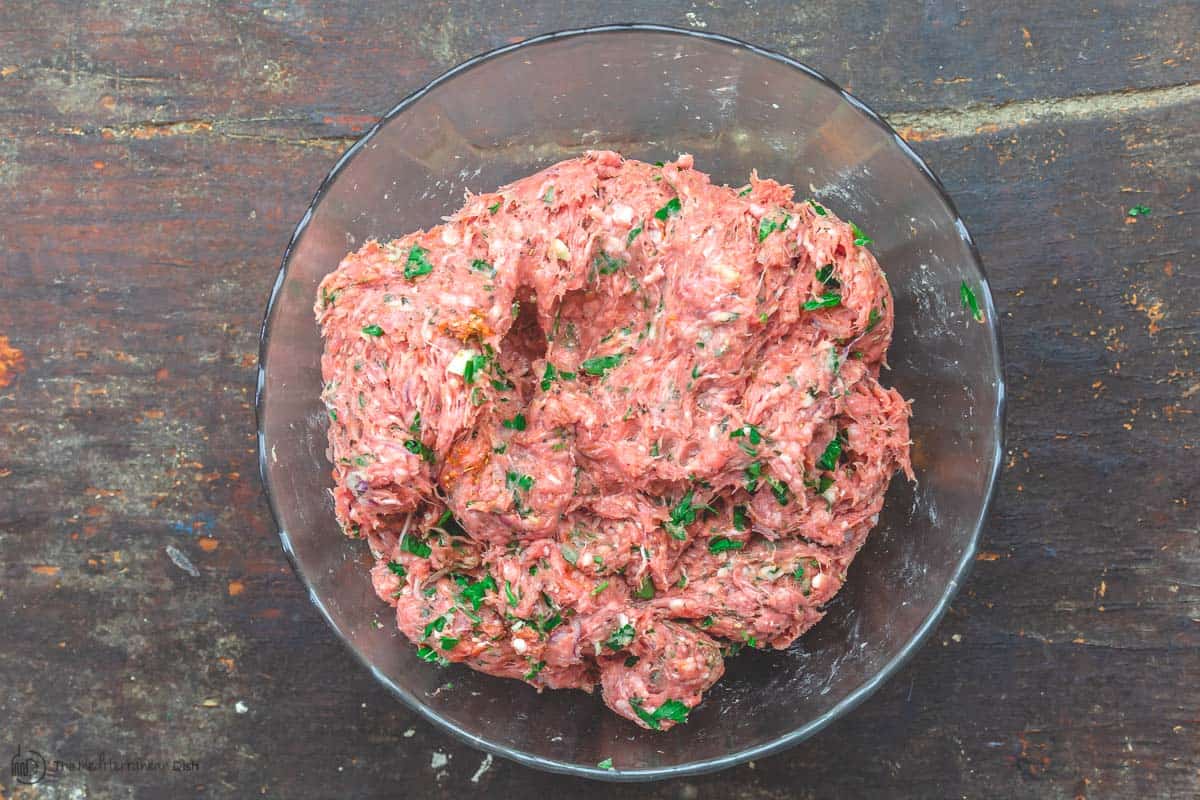 Meat mixture for greek lamb burgers placed in a bowl
