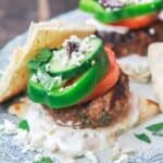 Greek lamb burgers with tzatziki sauce, vegetables, feta and olives