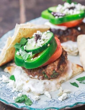 Greek lamb burgers with tzatziki sauce, vegetables, feta and olives
