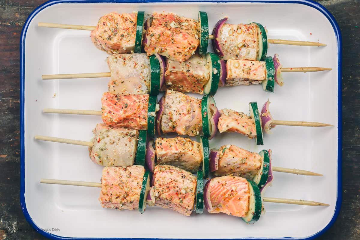 Salmon prepared on skewers with zucchini and red onion