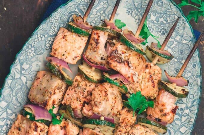 Mediterranean salmon kabobs served on a plate with tahini sauce