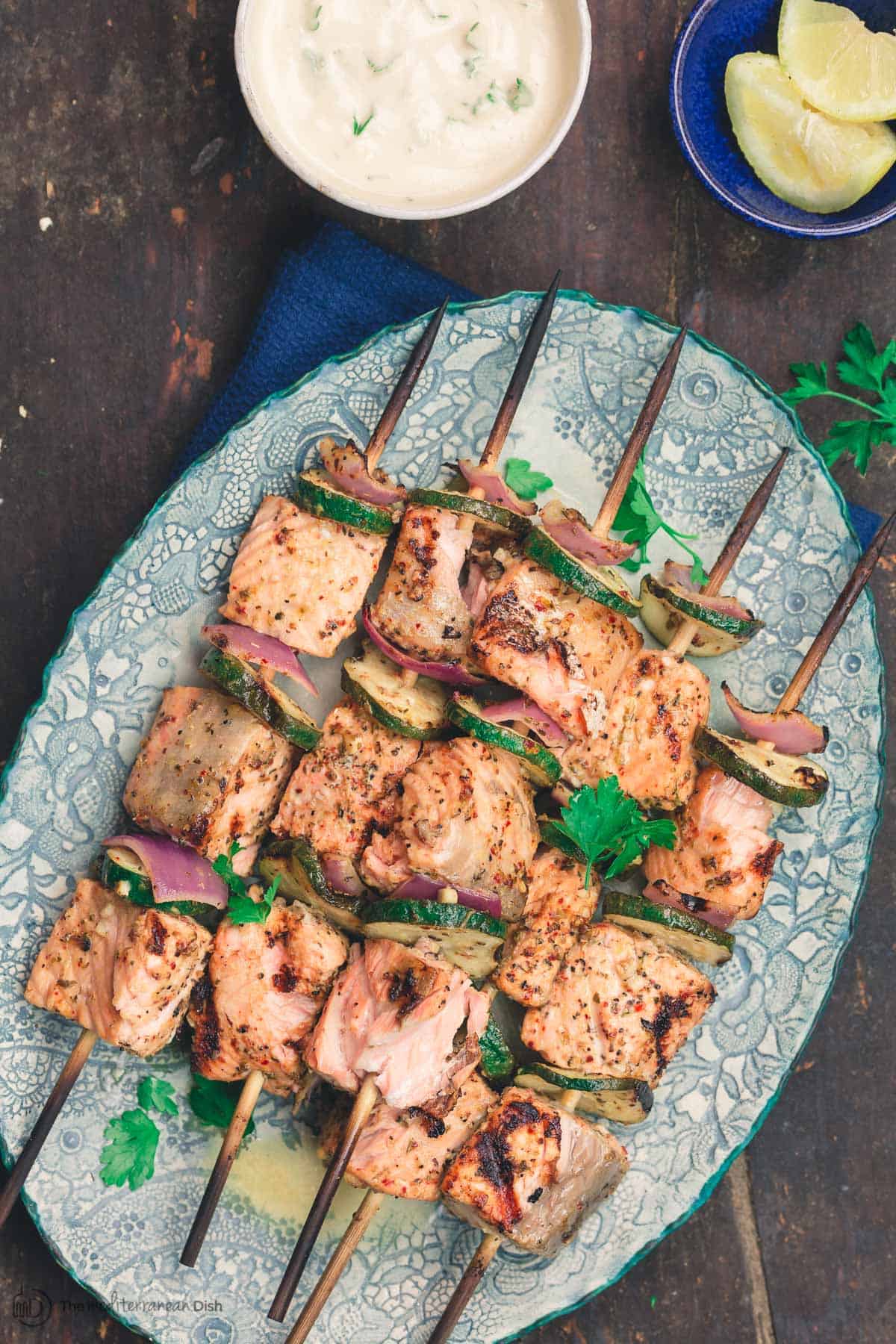 Mediterranean salmon kabobs served on a plate with tahini sauce